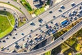 Aerial drone view of road interchange or highway intersection with busy urban traffic in modern city during sunny day. Traffic jam