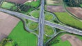 Aerial drone view road junction. Clover roundabout view from above. Car traffic on autobahn Germany. Royalty Free Stock Photo