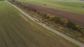 Aerial drone view on road, mooving cars and green field.View on highway, field and trees.