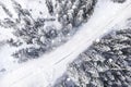 Aerial drone view of road in snowy forest Idyllic winter landscape