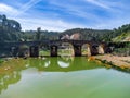 Aerial drone view of roman bridge in the hiking route of the water mills along the Odiel river from Sotiel Coronada