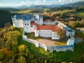Aerial drone view of Slovenska Lupca castle during autumn sunset from south