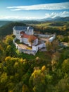 Aerial drone view of Slovenska Lupca castle during autumn sunset from south