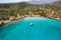 Aerial drone view of a small beach on a rocky, barren coastline and crystal clear ocean Kolokitha, Crete, Greece Royalty Free Stock Photo