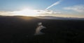 Aerial drone view of solar panels at a solar energy generation farm at Sunset.