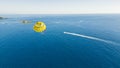 Aerial drone view of stunning seawaters near Okurcalar, Turkey. Brave tourist using a yellow parachute to admire the Royalty Free Stock Photo