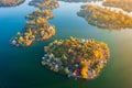 Aerial drone view of tiny fishing island on Lake Kavicsos near Budapest. The island is full with fishing huts, piers and cabins.