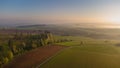 Aerial drone view to long paths between huge fields at sunny morning.