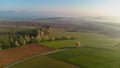 Aerial drone view to long paths between huge fields at sunny morning.