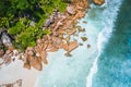Aerial drone view of tropical paradise like beach with pure crystal clear turquoise water, bizarre granite rocks and
