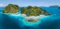 Aerial drone view of tropical Shimizu Island steep rocks and white sand beach in blue water El Nido, Palawan Royalty Free Stock Photo