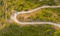 Aerial drone view of a twisty road on the countryside in Corfu Greece.