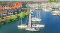 Aerial drone view of typical modern Dutch houses and marina in harbor, architecture of port of Volendam town, Holland, Netherlands