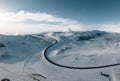 aerial drone view Uphill road landscape in winter at Iceland. Asphalt road with sideways full of snow during winter with Royalty Free Stock Photo