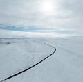 aerial drone view Uphill road landscape in winter at Iceland. Asphalt road with sideways full of snow during winter with Royalty Free Stock Photo