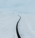 aerial drone view Uphill road landscape in winter at Iceland. Asphalt road with sideways full of snow during winter with Royalty Free Stock Photo