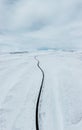 aerial drone view Uphill road landscape in winter at Iceland. Asphalt road with sideways full of snow during winter with Royalty Free Stock Photo