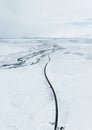 aerial drone view Uphill road landscape in winter at Iceland. Asphalt road with sideways full of snow during winter with Royalty Free Stock Photo