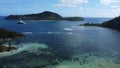 A bay in the island of MahÃ©, Seychelles with a white boat and green islands in the background