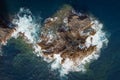 aerial drone view of waves crashing against the rocks of a cliff Royalty Free Stock Photo