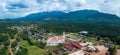 Aerial drone view of a white mosque known as Tun Khalil Mosque with Mount Ledang background at Asahan, Melaka, Malaysia.