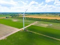 Aerial drone view of wind power turbines, part of a wind farm. Wind turbines on green field in countryside. Wind power plant Royalty Free Stock Photo