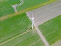 Aerial drone view of wind power turbines, part of a wind farm. Wind turbines on green field in countryside. Wind power plant Royalty Free Stock Photo