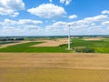 Aerial drone view of wind power turbines, part of a wind farm. Wind turbines on green field in countryside. Wind power plant Royalty Free Stock Photo