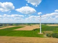 Aerial drone view of wind power turbines, part of a wind farm. Wind turbines on green field in countryside. Wind power plant Royalty Free Stock Photo