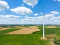 Aerial drone view of wind power turbines, part of a wind farm. Wind turbines on green field in countryside. Wind power plant Royalty Free Stock Photo