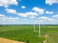 Aerial drone view of wind power turbines, part of a wind farm. Wind turbines on green field in countryside. Wind power plant Royalty Free Stock Photo