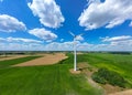 Aerial drone view of wind power turbines, part of a wind farm. Wind turbines on green field in countryside. Wind power plant Royalty Free Stock Photo