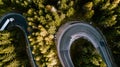 Aerial drone view of winding forest road in the mountains. Colourful landscape with rural road, trees with yellow leaves Royalty Free Stock Photo