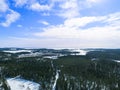 Aerial drone view of a winter landscape. Snow covered forest and lakes from the top. Sunrise in nature from a birds eye view. Royalty Free Stock Photo