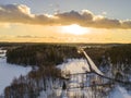 Aerial drone view of a winter landscape. Snow covered forest and lakes from the top. Sunrise in nature from a birds eye view. Royalty Free Stock Photo