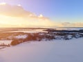 Aerial drone view of a winter landscape. Snow covered forest and lakes from the top. Sunrise in nature from a birds eye view. Aer Royalty Free Stock Photo