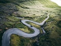 Aerial drone view of zigzag road with one car in open space