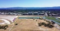 Aerial of dry grass at Bedwell bayfront park in menlo park with mounatins and corporate buildings