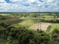 Aerial of an electric pylon and undeveloped farmland in Dasmarinas Cavite