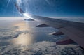 Aerial evening sky and clouds view above ocean from airplane porthole Royalty Free Stock Photo