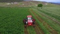 Aerial farm tractor cutting hay swather circle 4K