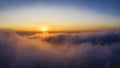Aerial flight high through beautiful clouds during sunset time