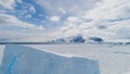 Aerial flight over Antarctica iceberg, ocean.