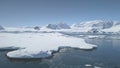 Aerial flight over Antarctica shoreline, ocean.