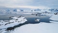 Aerial flight over Antarctica snow shoreline.
