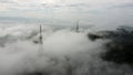 Aerial fly away view the foggy cloud cover telco tower