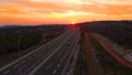 AERIAL: Flying above cars speeding up and down the new highway built in Croatia. Royalty Free Stock Photo