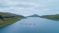 AERIAL: Flying above a large fish farm near remote coastal town in Faroe Islands