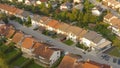 AERIAL: Flying above the luxury terraced houses in calm suburban neighborhood. Royalty Free Stock Photo