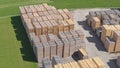 AERIAL: Flying above a neatly organized lumberyard in sunny Austrian countryside